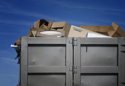 Crew loading mixed waste into a skip during a rubbish collection